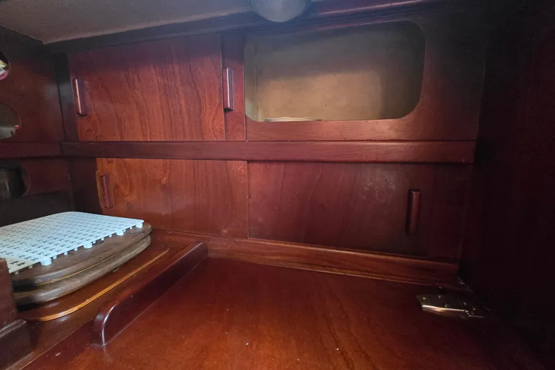 Blue Song Yacht Photos Pics Interior of 1984 Amel Maramu 45 sailboat with wooden cabinetry and storage space.