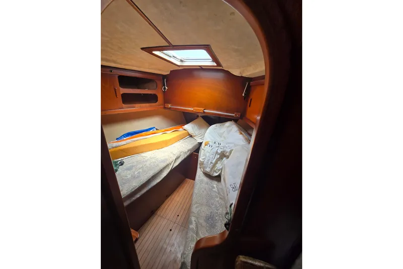 Blue Song Yacht Photos Pics Cozy cabin interior of 1984 Amel Maramu 45 sailboat with wooden finish.