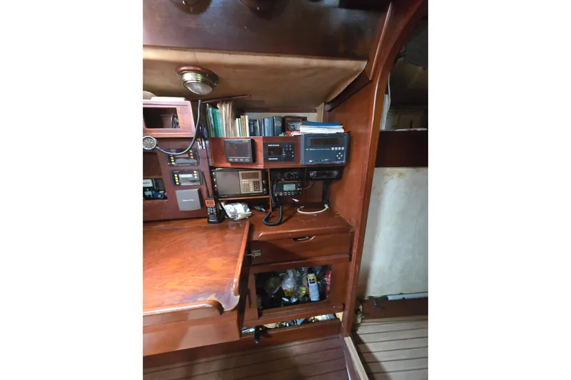 Blue Song Yacht Photos Pics Navigation station on 1984 Amel Maramu 45 sailboat with wooden interior and equipment.