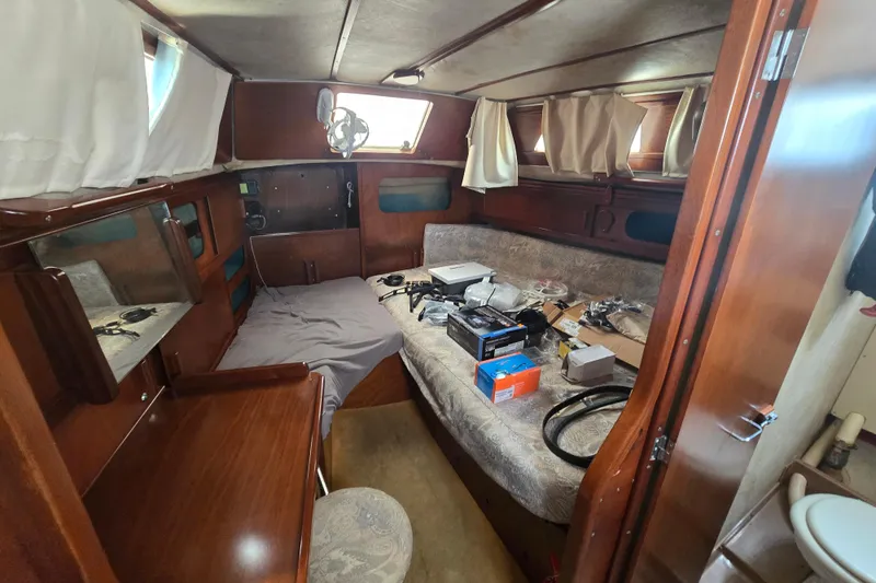 Blue Song Yacht Photos Pics Interior of 1984 Amel Maramu 45 sailboat cabin with equipment and wooden furnishings.
