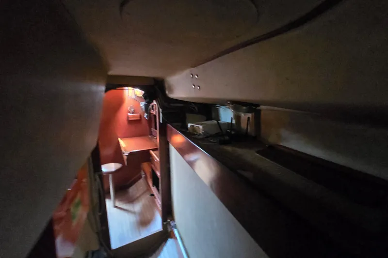 Blue Song Yacht Photos Pics Interior view of 1984 Amel Maramu 45 sailboat, featuring cozy wooden cabin space.