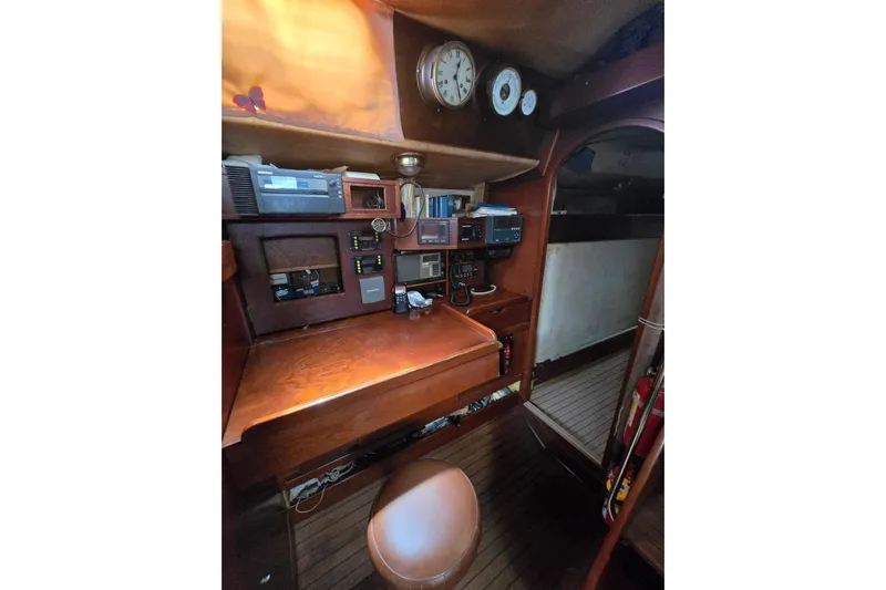 Blue Song Yacht Photos Pics Navigation station of 1984 Amel Maramu 45 yacht with wooden interior and instruments.