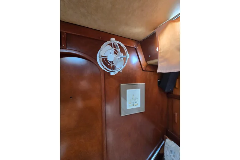 Blue Song Yacht Photos Pics Interior of 1984 Amel Maramu 45 sailboat with fan and framed artwork.