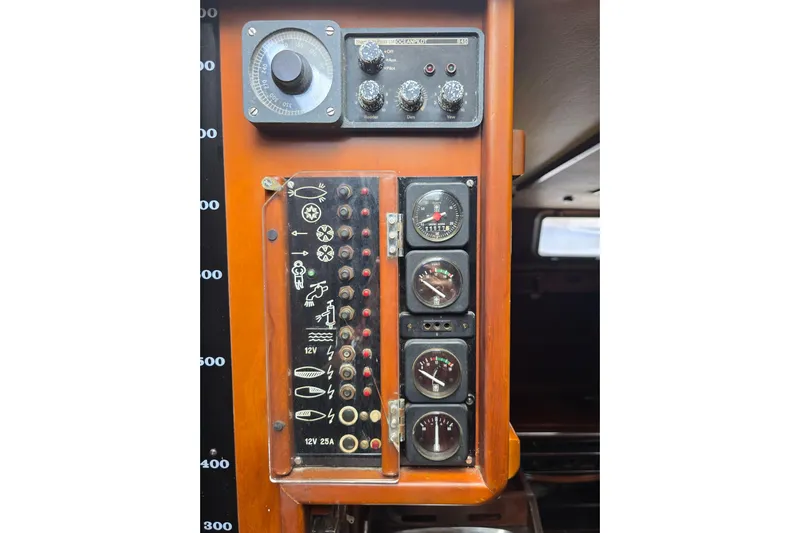 Blue Song Yacht Photos Pics Control panel of a 1984 Amel Maramu 45 sailboat with gauges and switches.