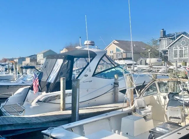  Yacht Photos Pics 2016 Sea Ray 330 Sundancer docked in a marina under clear blue skies.