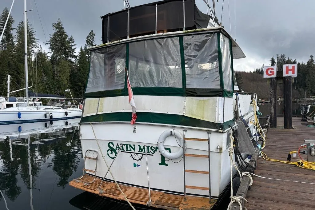 1977 Pacemaker 40 Motor Yacht docked, featuring green and white exterior with covered deck.