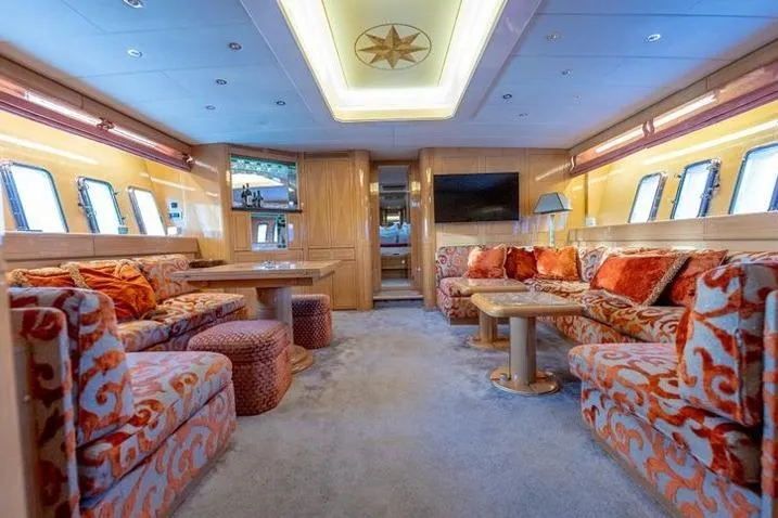  Yacht Photos Pics Luxurious 1999 Mangusta 80 yacht interior with plush seating and elegant decor.