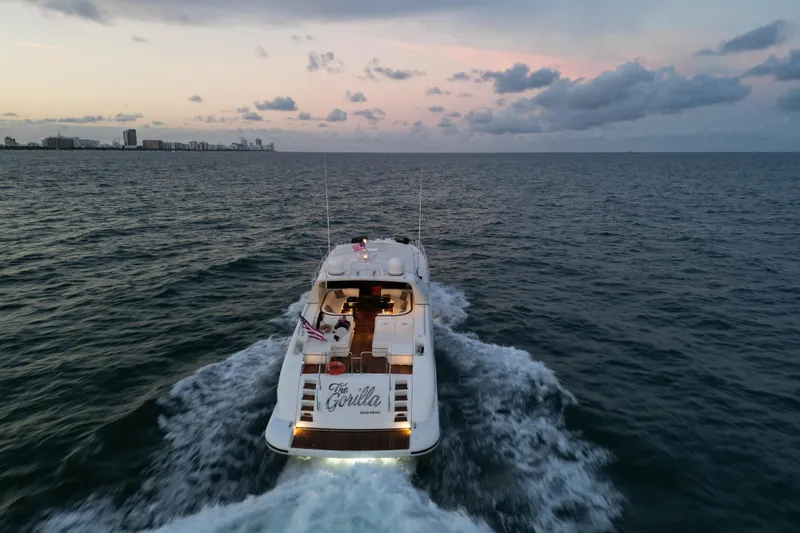  Yacht Photos Pics Luxury 1999 Mangusta 80 yacht cruising at sunset on open sea.