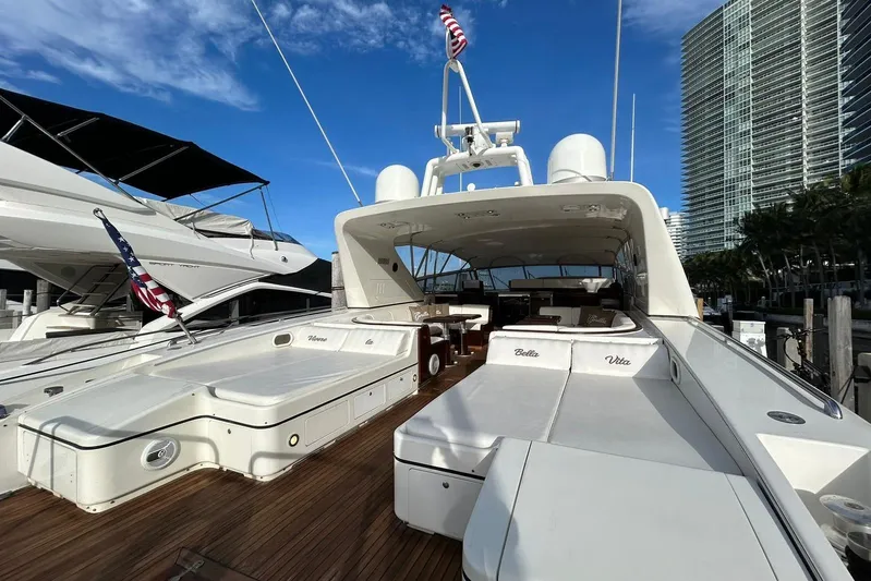  Yacht Photos Pics Luxurious 1999 Mangusta 80 yacht docked, featuring spacious deck and elegant design.