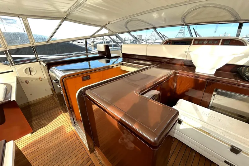  Yacht Photos Pics 1999 Mangusta 80 yacht interior with polished wood and modern design elements.
