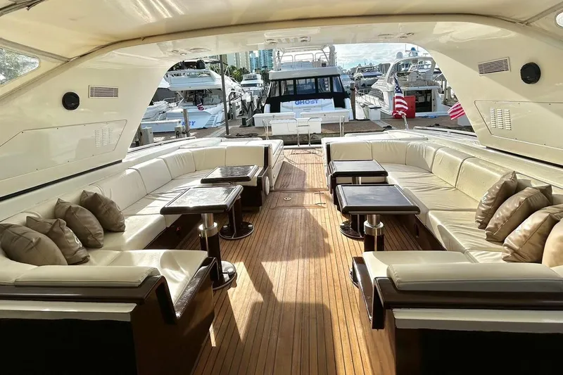  Yacht Photos Pics Luxurious 1999 Mangusta 80 yacht interior with elegant seating and wooden flooring.