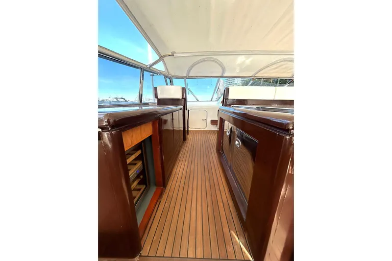 Yacht Photos Pics 1999 Mangusta 80 yacht interior with wooden flooring and sleek cabinetry.