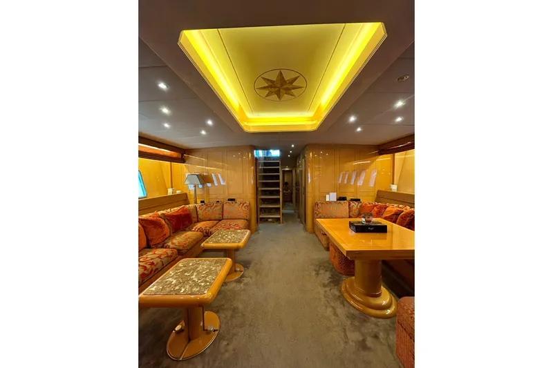  Yacht Photos Pics Luxurious interior of 1999 Mangusta 80 yacht with elegant seating and ambient lighting.
