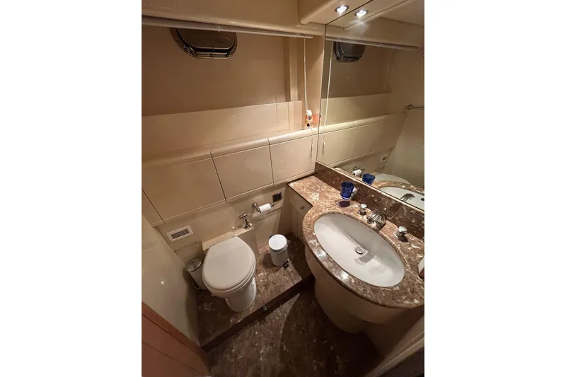  Yacht Photos Pics Luxurious bathroom in 1999 Mangusta 80 yacht with marble countertop and modern fixtures.