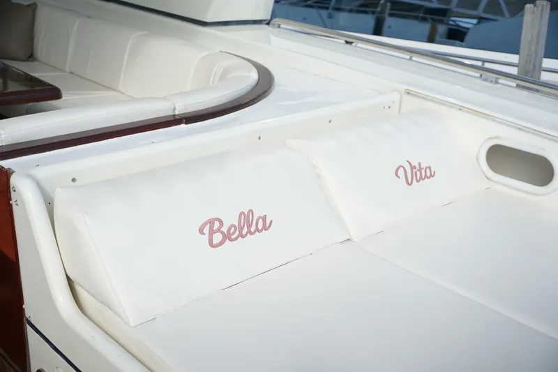  Yacht Photos Pics 1999 Mangusta 80 yacht with "Bella Vita" cushions, white seating area.