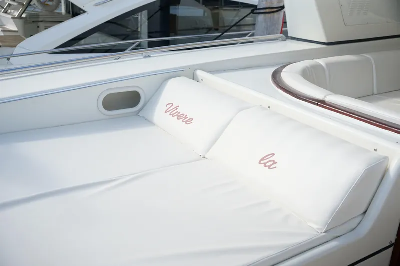  Yacht Photos Pics Luxurious 1999 Mangusta 80 yacht with white cushioned seating.