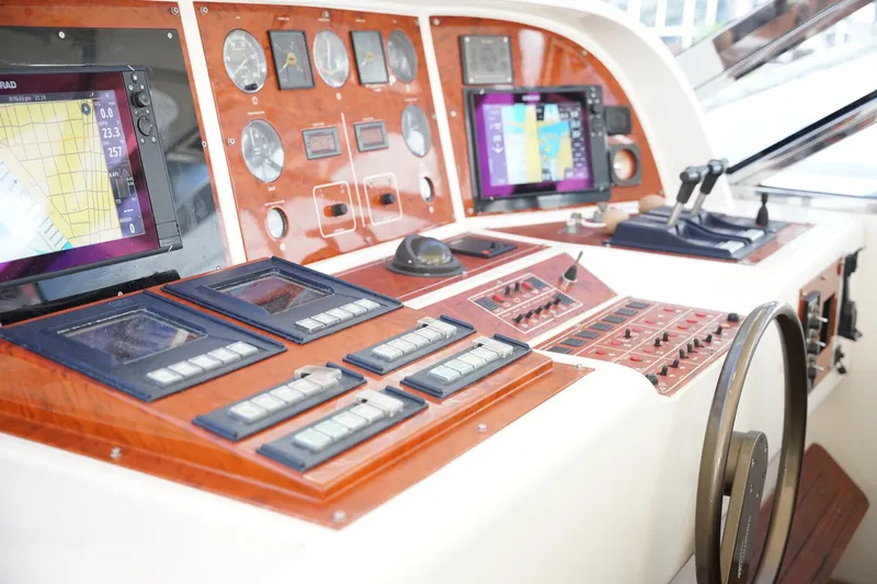  Yacht Photos Pics Control panel of a 1999 Mangusta 80 yacht with navigation screens and gauges.