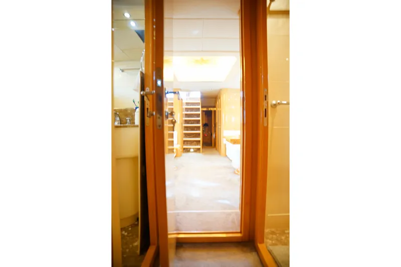  Yacht Photos Pics Interior view of 1999 Mangusta 80 yacht, featuring a luxurious hallway and staircase.