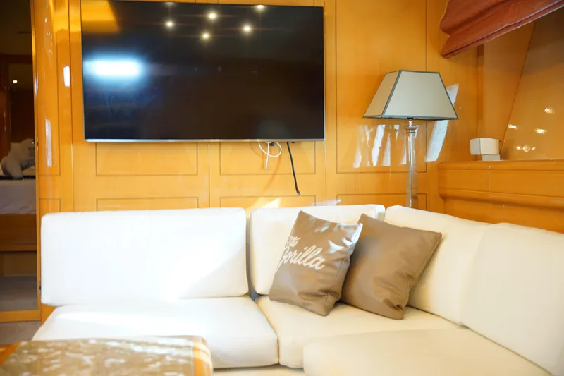  Yacht Photos Pics Luxurious Mangusta 80 yacht interior, featuring a modern TV, white sofa, and stylish decor.