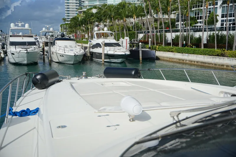  Yacht Photos Pics 1999 Mangusta 80 yacht docked in a marina with other luxury boats.