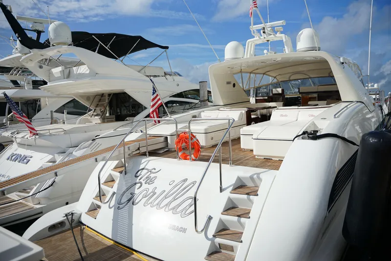  Yacht Photos Pics Luxurious 1999 Mangusta 80 yacht docked, featuring spacious deck and elegant design.