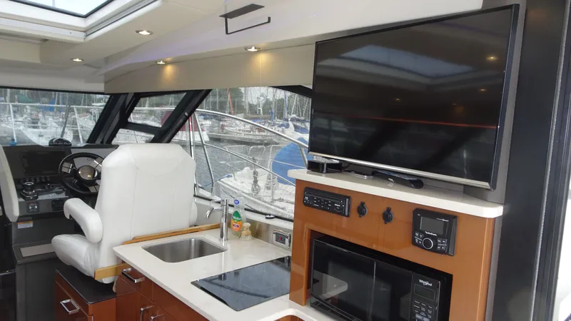 Sc Yacht Photos Pics Interior of 2018 Carver C34 Coupe yacht with helm, TV, and kitchenette.