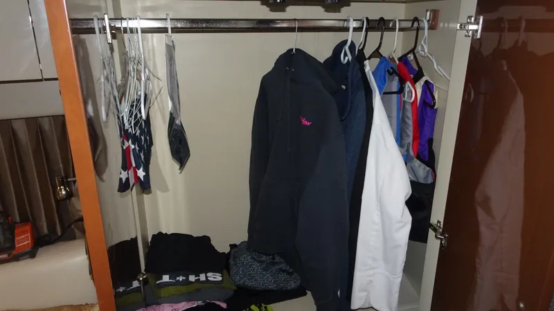 Sc Yacht Photos Pics Closet inside 2018 Carver C34 Coupe with hanging clothes and folded garments.