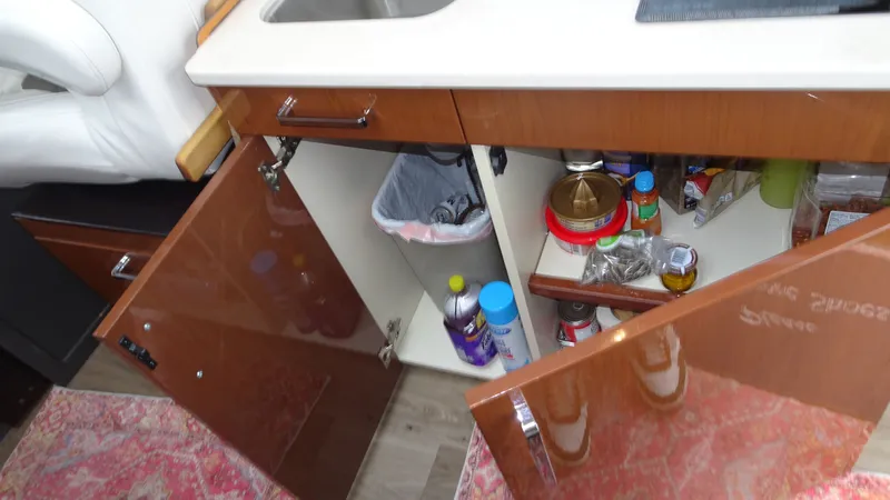 Sc Yacht Photos Pics Interior of 2018 Carver C34 Coupe showing open kitchen cabinets with various items.