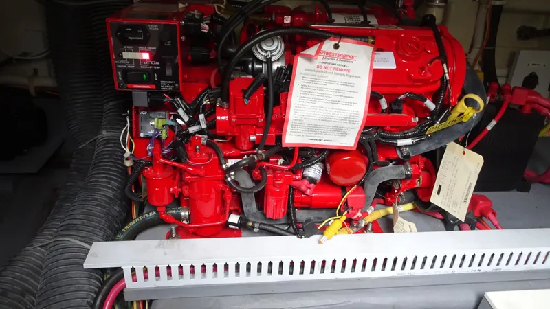 Sc Yacht Photos Pics Engine compartment of a 2018 Carver C34 Coupe with red mechanical components.