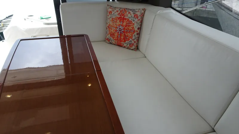 Sc Yacht Photos Pics Luxurious interior of 2018 Carver C34 Coupe with white seating and decorative pillow.