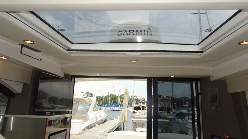 Sc Yacht Photos Pics Interior view of 2018 Carver C34 Coupe yacht with skylight and marina backdrop.
