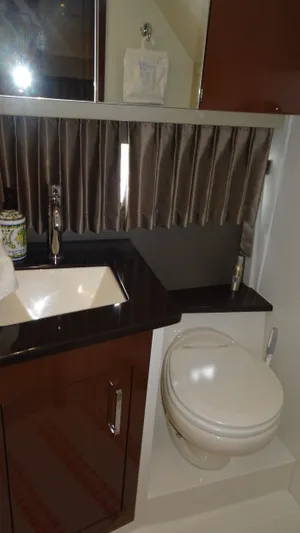 Sc Yacht Photos Pics 2018 Carver C34 Coupe bathroom with sink, toilet, and curtain.