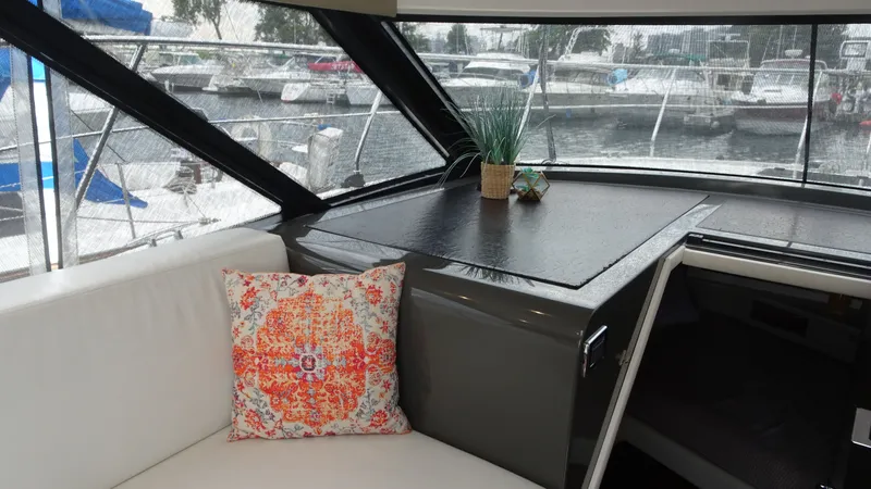 Sc Yacht Photos Pics Interior of 2018 Carver C34 Coupe with decorative pillow and marina view.