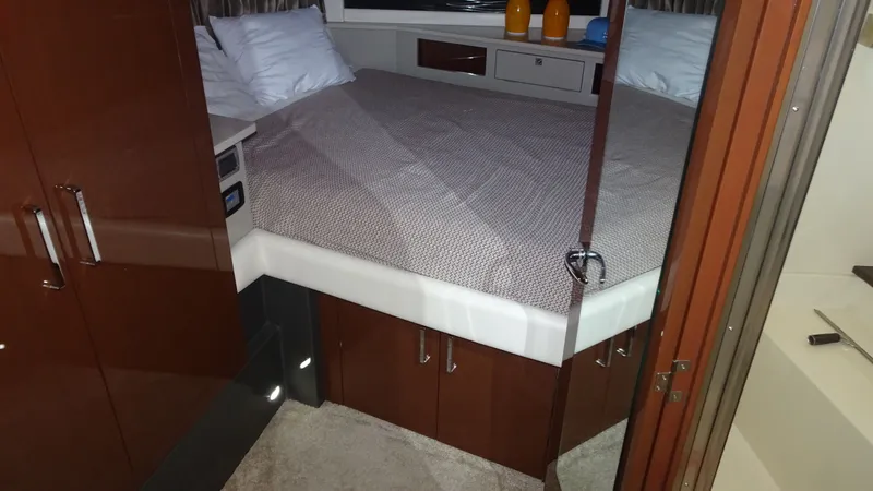 Sc Yacht Photos Pics Interior cabin of 2018 Carver C34 Coupe with bed and wooden cabinetry.