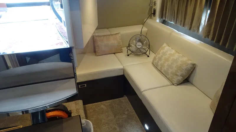 Sc Yacht Photos Pics Luxurious interior of 2018 Carver C34 Coupe with white seating and decorative pillows.