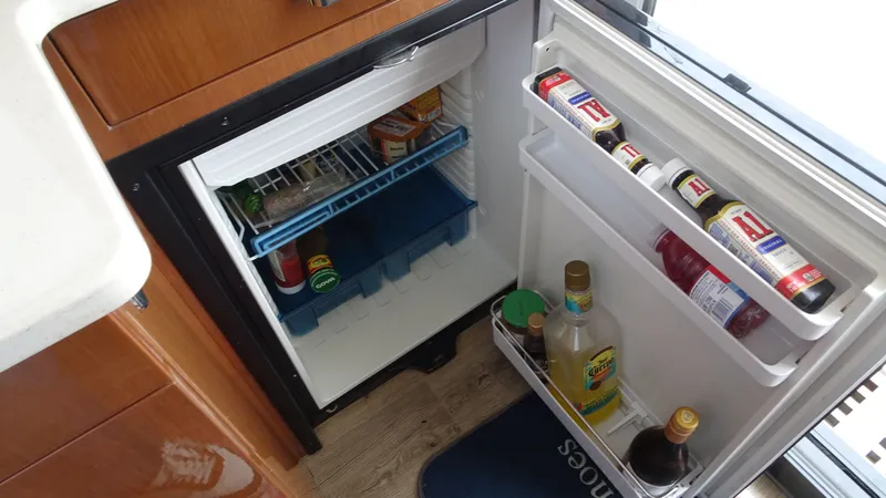 Sc Yacht Photos Pics Mini fridge inside 2018 Carver C34 Coupe, stocked with beverages and condiments.