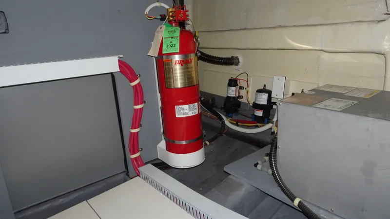 Sc Yacht Photos Pics Engine room of 2018 Carver C34 Coupe with fire extinguisher and equipment.