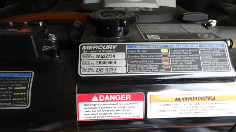 Sc Yacht Photos Pics Engine maintenance labels on a 2018 Carver C34 Coupe, featuring Mercury maintenance schedule.