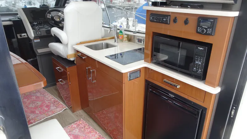 Sc Yacht Photos Pics Interior of 2018 Carver C34 Coupe yacht with kitchenette and helm station.