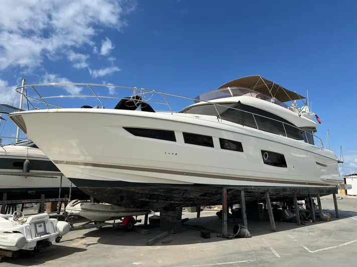  Yacht Photos Pics 2014 Prestige 550 yacht on dry dock under a clear blue sky.