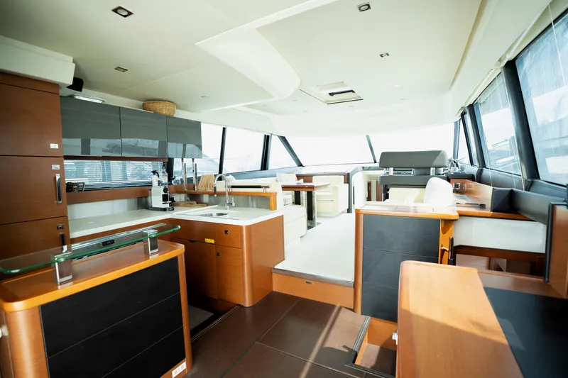  Yacht Photos Pics Luxurious interior of a 2014 Prestige 550 yacht with modern kitchen and seating area.