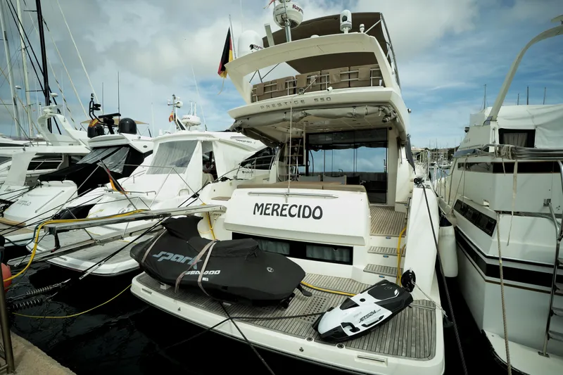  Yacht Photos Pics Luxury 2014 Prestige 550 yacht docked with jet skis on deck.