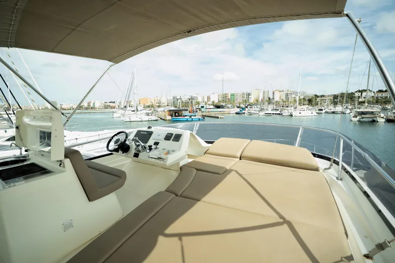  Yacht Photos Pics Luxurious 2014 Prestige 550 yacht with spacious deck, docked in a scenic marina.