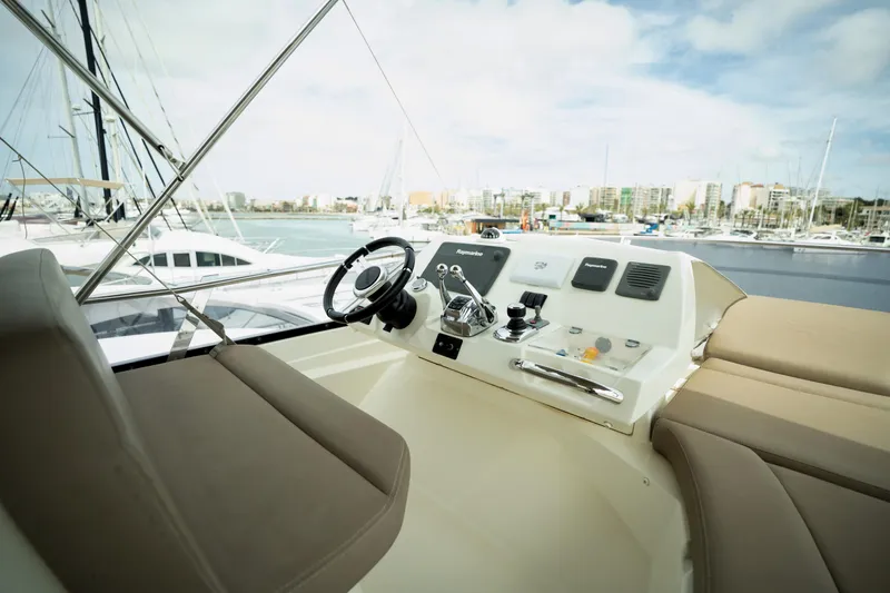  Yacht Photos Pics Flybridge of 2014 Prestige 550 yacht with helm station and marina view.