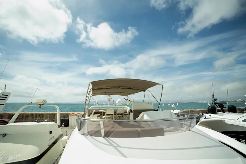  Yacht Photos Pics Luxury 2014 Prestige 550 yacht docked under a bright blue sky.