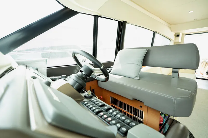  Yacht Photos Pics Interior of 2014 Prestige 550 yacht with modern helm and seating area.