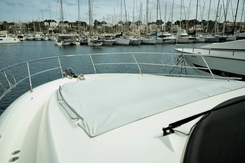  Yacht Photos Pics Prestige 550 yacht in marina, 2014 model, surrounded by sailboats and calm waters.