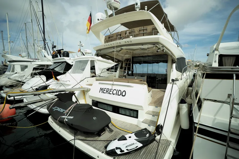  Yacht Photos Pics Luxury yacht Prestige 550, 2014 model, docked with jet skis on deck.