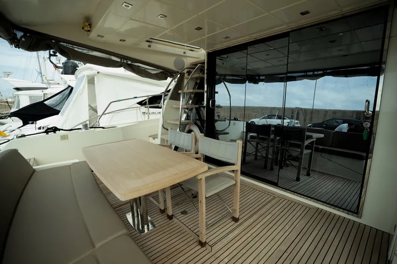  Yacht Photos Pics Luxurious 2014 Prestige 550 yacht deck with seating and glass doors.