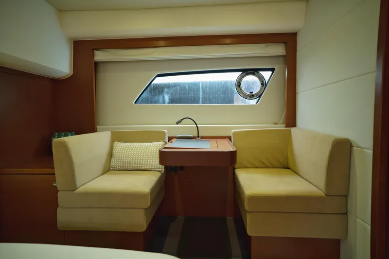  Yacht Photos Pics Luxurious interior of 2014 Prestige 550 yacht with cozy seating and window view.